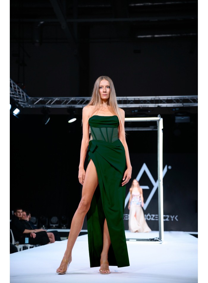 Emerald green evening dress with corset and high leg slit.