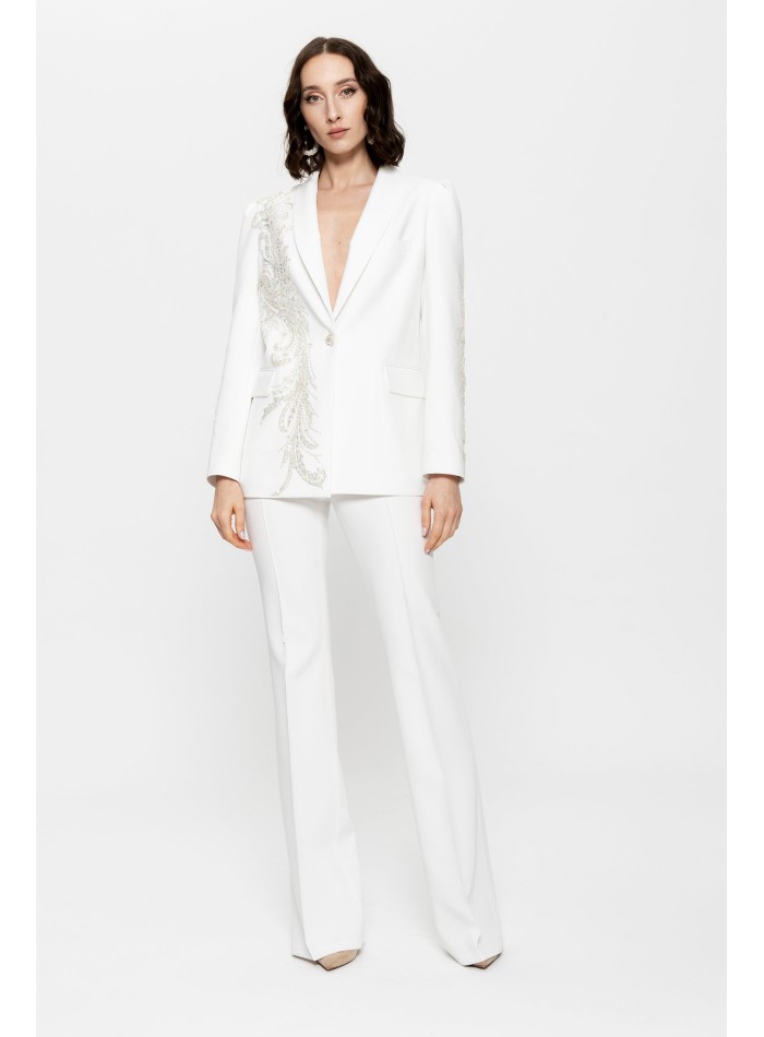 White pants suit for women with embroidered blazer and silver details.