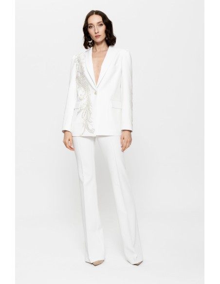 White pants suit for women with embroidered blazer and silver details.