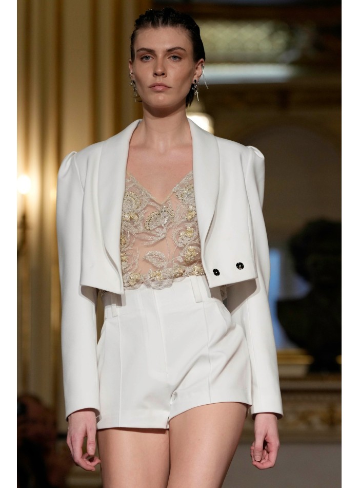 Short white blazer with long sleeves and...