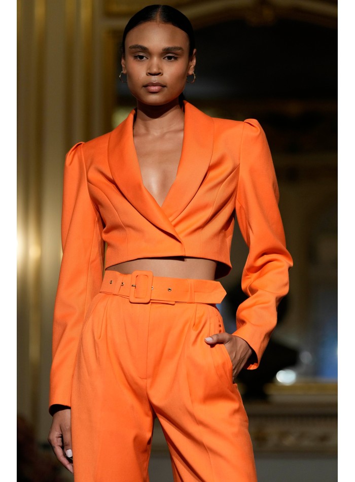 Short orange blazer with long, puffed sleeves