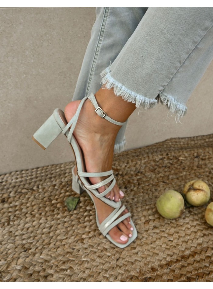 Green party sandal with straps tied at the ankle