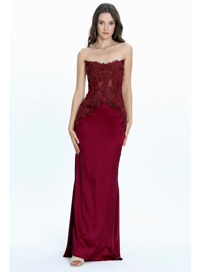 Long burgundy dress with strapless neckline and rhinestone details