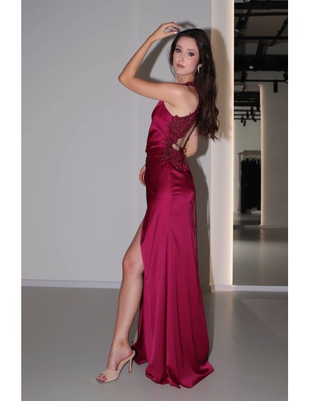 Long burgundy satin dress with slit, halter neckline and rhinestones