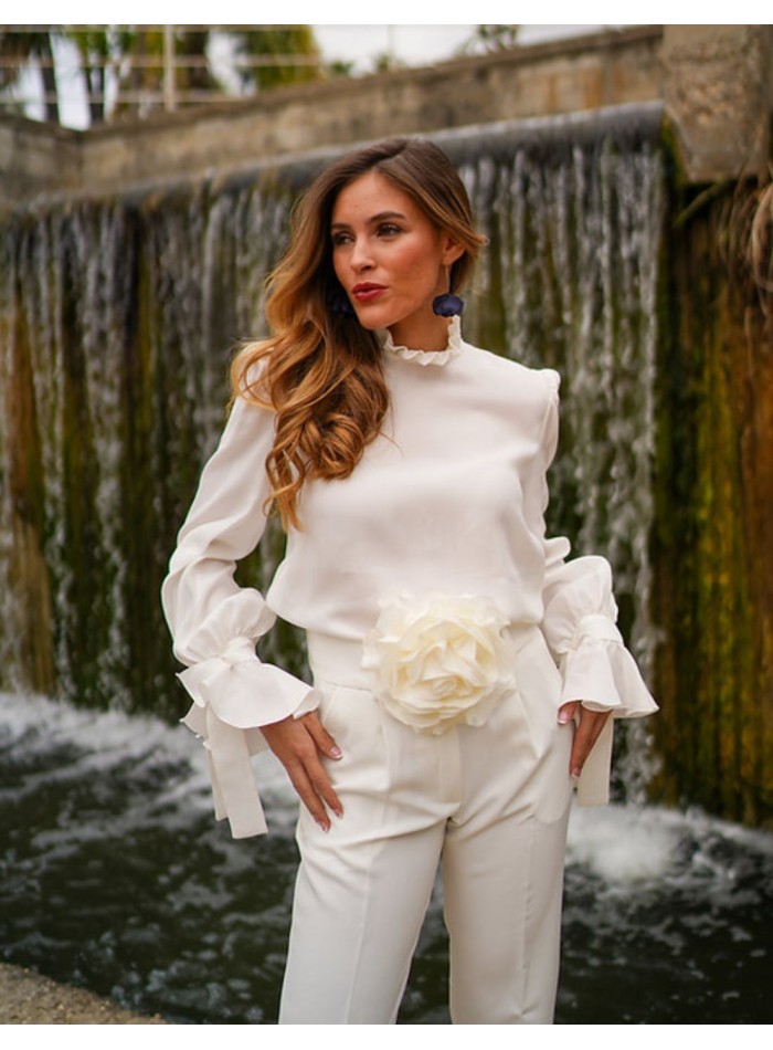 White blouse with long sleeves and ruffled details