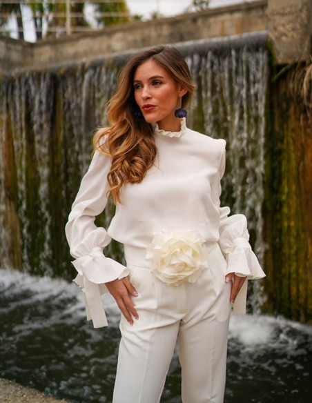 White blouse with long sleeves and ruffled details